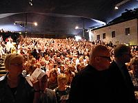 over 1000 spectators sitting expectantly in the courtyard Savonlinna